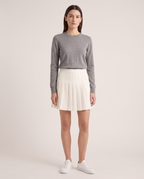 Model wearing the Pleated Mini Skirt in Ecru