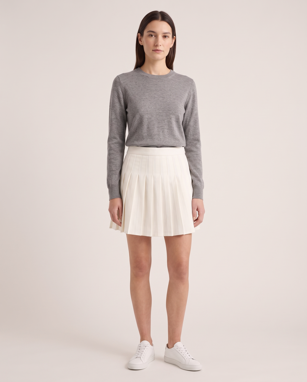 Model wearing the Pleated Mini Skirt in Ecru